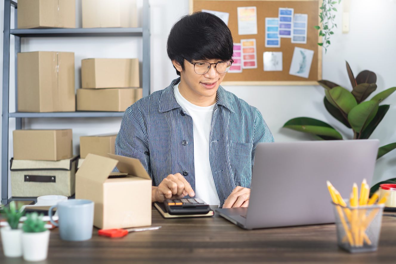 Man using a computer for retail shipping.